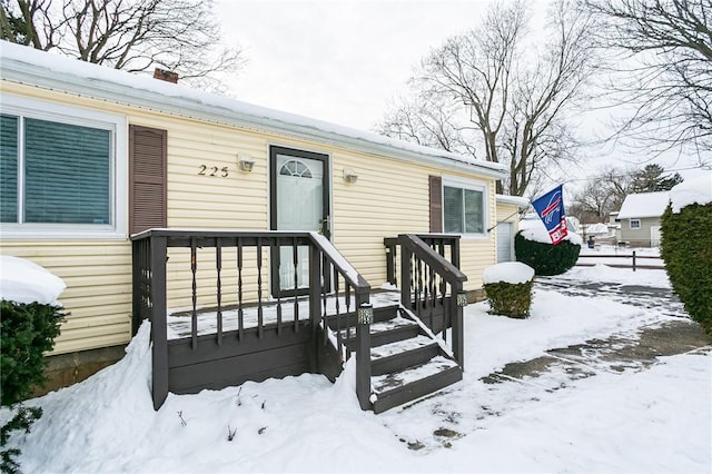 view of snow covered property entrance