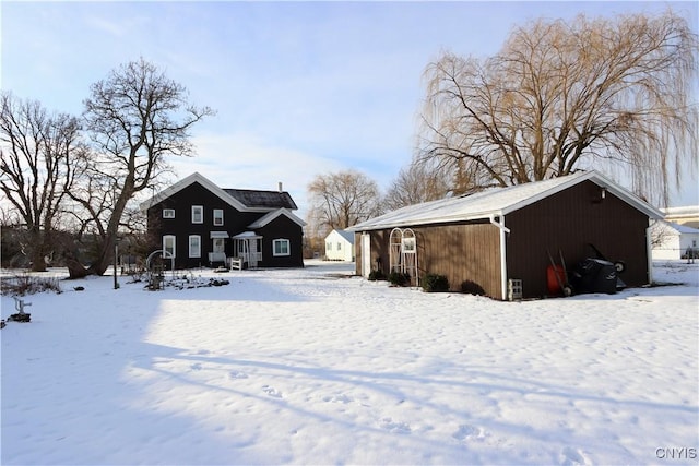 view of snow covered rear of property