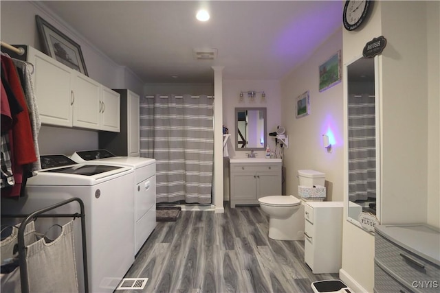 laundry room with washing machine and dryer and dark hardwood / wood-style flooring