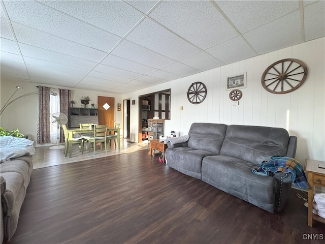 living room featuring hardwood / wood-style flooring and a drop ceiling