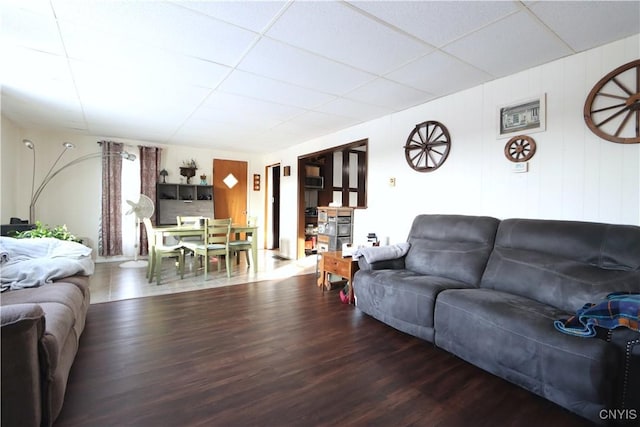 living room with hardwood / wood-style flooring and a drop ceiling