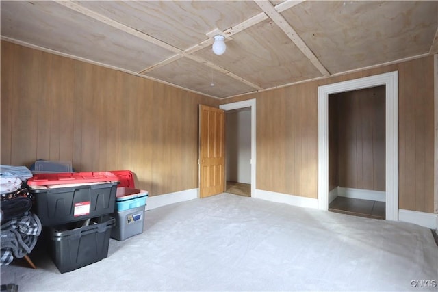 interior space with ceiling fan and wooden walls