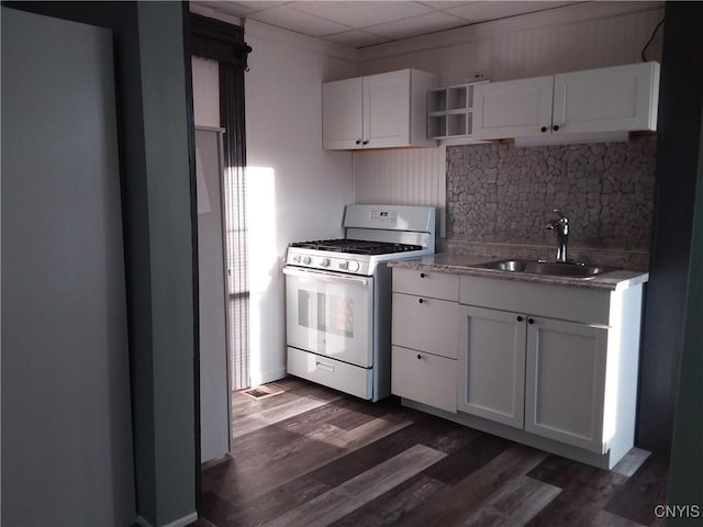 kitchen featuring sink, white cabinets, decorative backsplash, white range with gas cooktop, and dark wood-type flooring