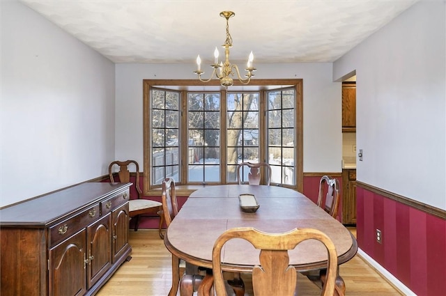 dining area with a notable chandelier and light wood-type flooring