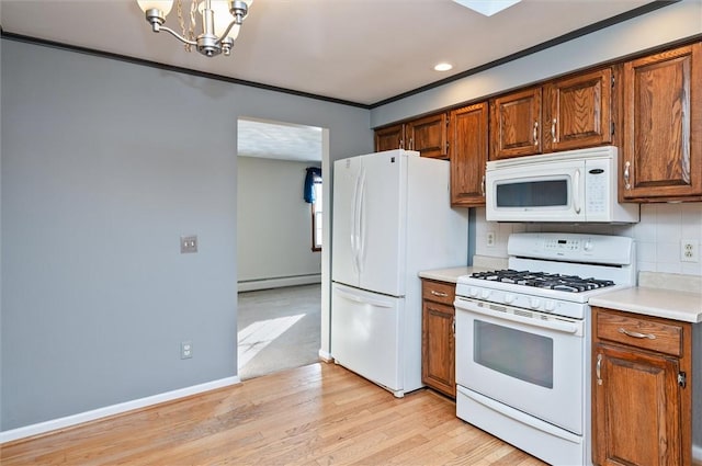 kitchen with a baseboard radiator, light hardwood / wood-style flooring, white appliances, an inviting chandelier, and decorative backsplash