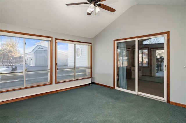 spare room with vaulted ceiling, carpet flooring, and ceiling fan