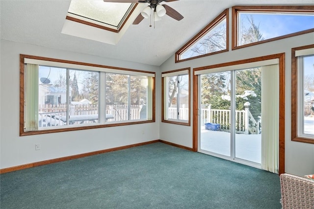 unfurnished sunroom featuring ceiling fan and lofted ceiling with skylight