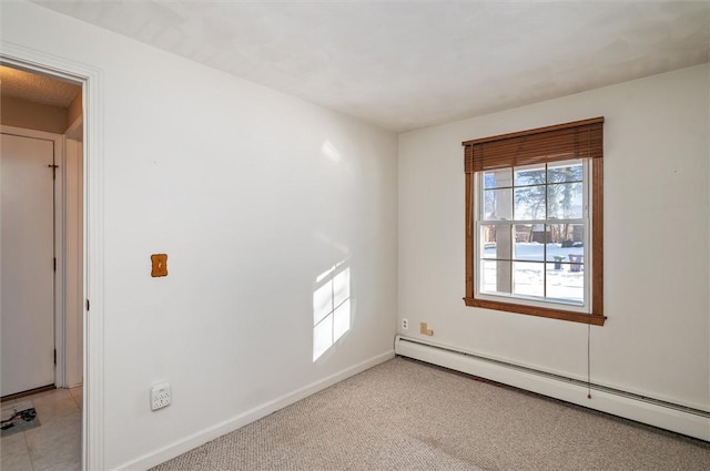 unfurnished room featuring light carpet and a baseboard radiator