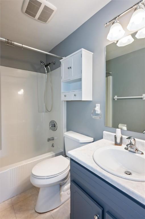 full bathroom with shower / bathtub combination, toilet, tile patterned floors, and vanity