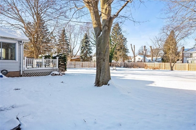 snowy yard featuring a wooden deck