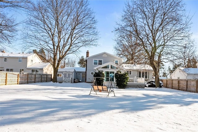 snow covered property featuring a wooden deck