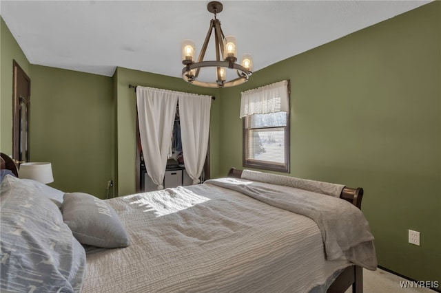 carpeted bedroom featuring a notable chandelier