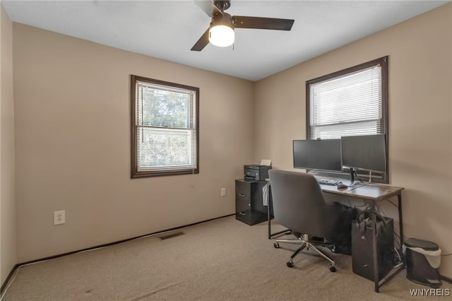 office area with light colored carpet and ceiling fan