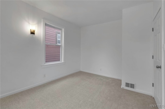 spare room with light carpet