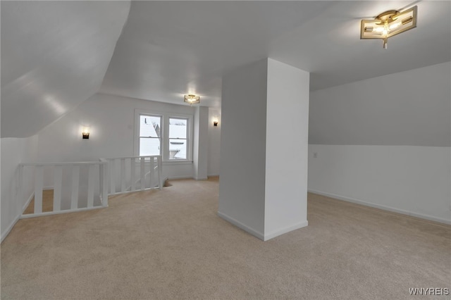 additional living space with light colored carpet and lofted ceiling