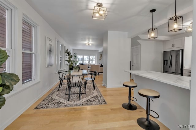 dining space with light wood-type flooring