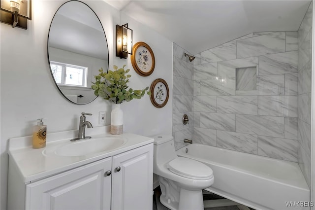 full bathroom featuring tiled shower / bath combo, toilet, and vanity