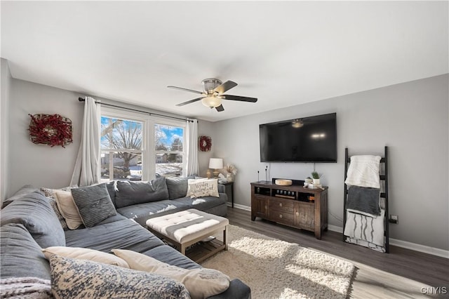 living room with dark wood-type flooring and ceiling fan