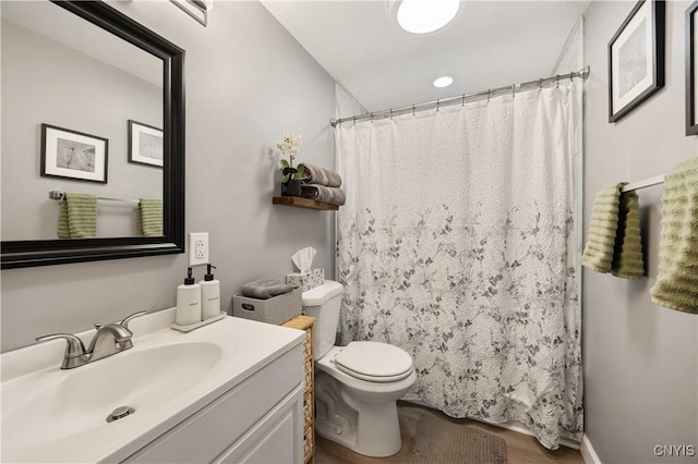 bathroom featuring vanity, toilet, and a shower with shower curtain