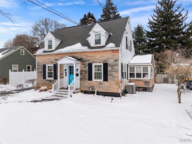 cape cod house featuring cooling unit