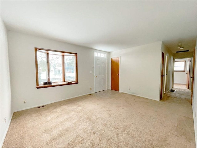 spare room with light carpet