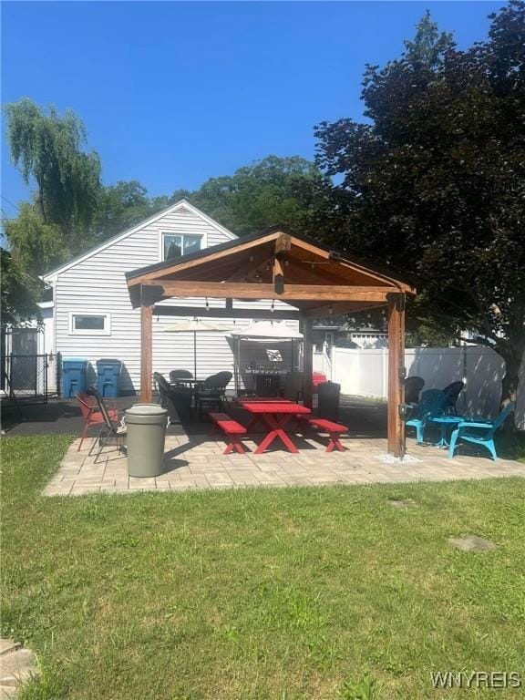 exterior space with an outdoor fire pit, a gazebo, a yard, and a patio