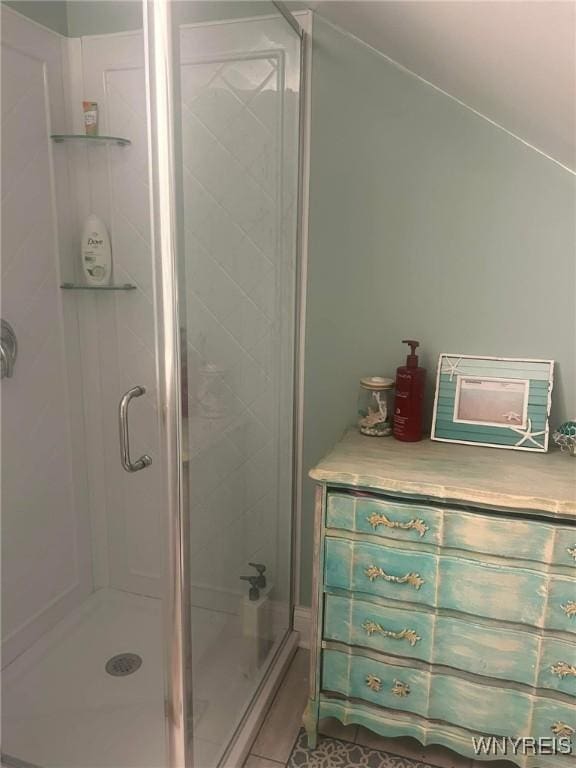 bathroom with tile patterned floors and walk in shower