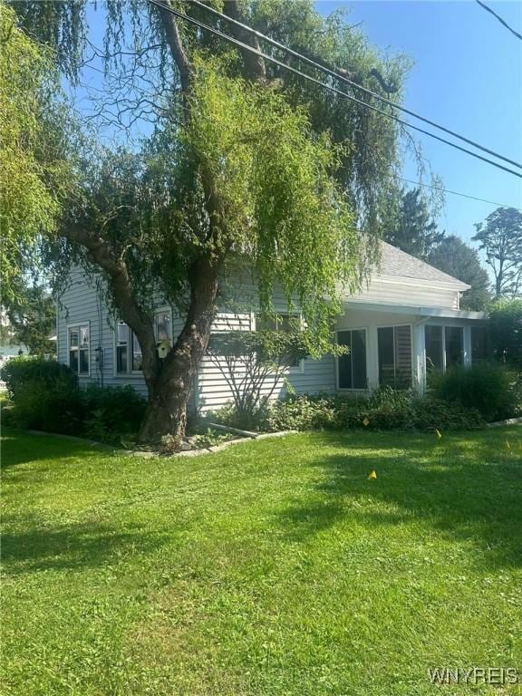 view of side of home featuring a yard