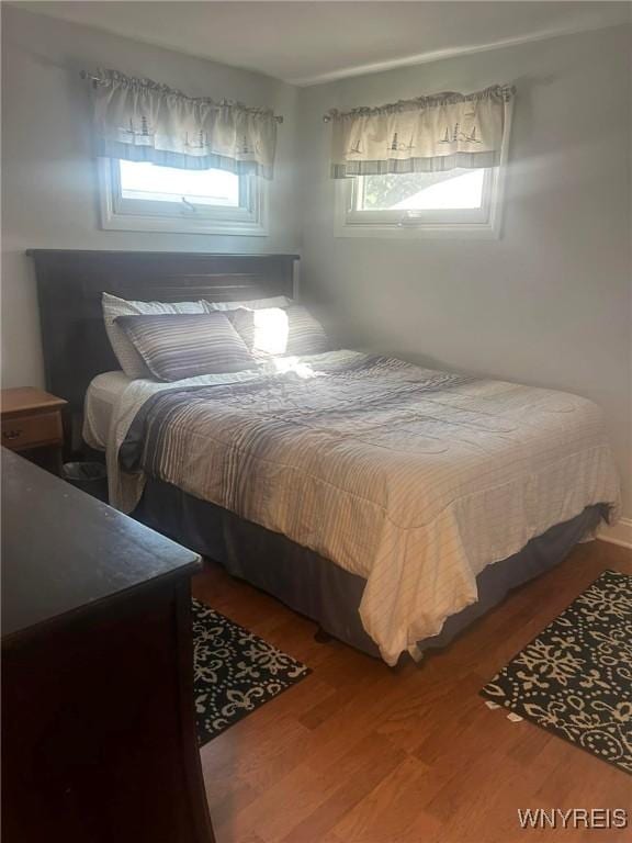 bedroom featuring hardwood / wood-style floors and multiple windows