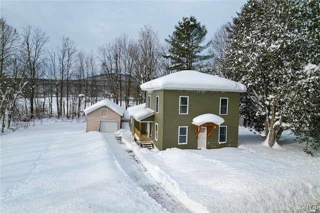 view of front of house featuring a garage and an outdoor structure