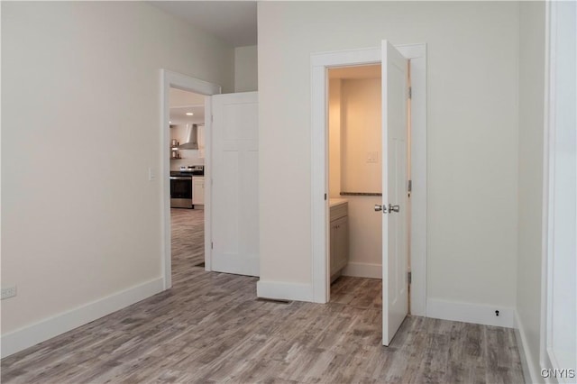 unfurnished bedroom with light wood-type flooring and baseboards