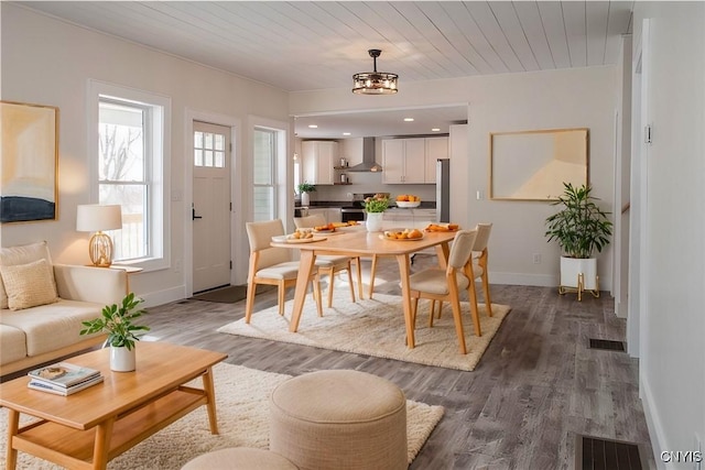 dining space with wooden ceiling, baseboards, visible vents, and dark wood-style flooring