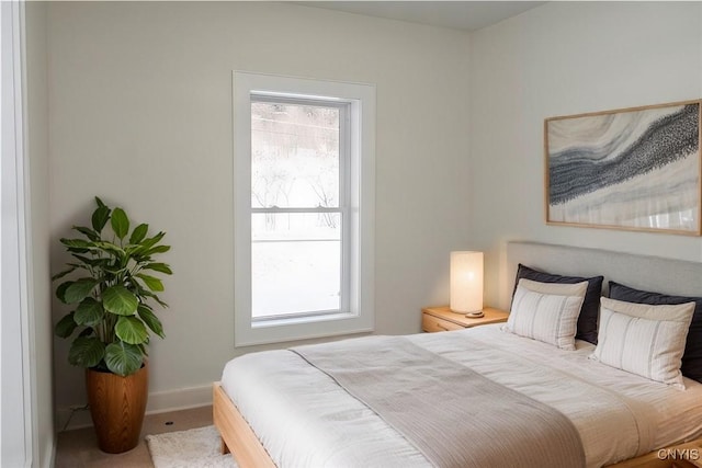 bedroom featuring multiple windows and baseboards