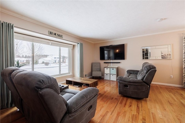 living room with light hardwood / wood-style flooring and crown molding