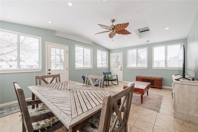 dining room featuring ceiling fan, light tile patterned floors, and lofted ceiling