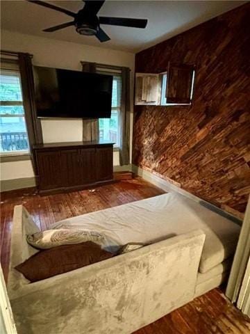 interior space with ceiling fan, dark wood-type flooring, and a wealth of natural light