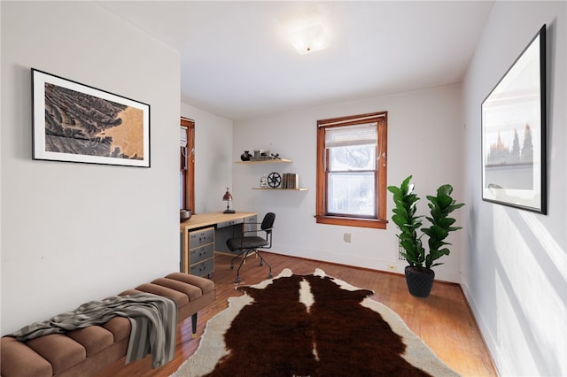 office area featuring built in desk and light hardwood / wood-style floors