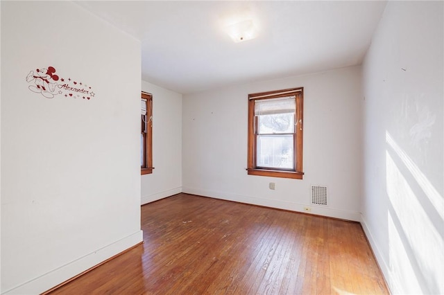 unfurnished room with wood-type flooring