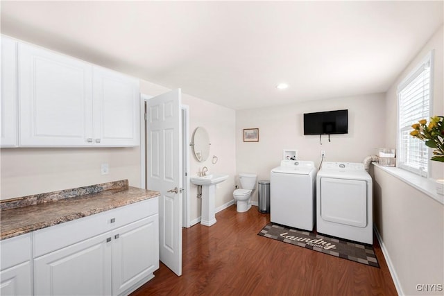 laundry room featuring dark wood-type flooring and washer and dryer