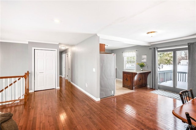 unfurnished room featuring light wood-type flooring and ornamental molding