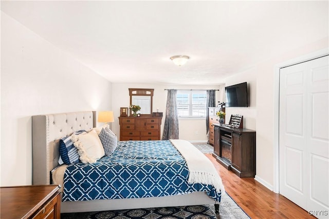 bedroom with a closet and light hardwood / wood-style floors