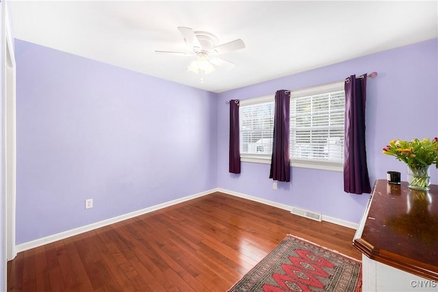 spare room featuring dark hardwood / wood-style floors and ceiling fan