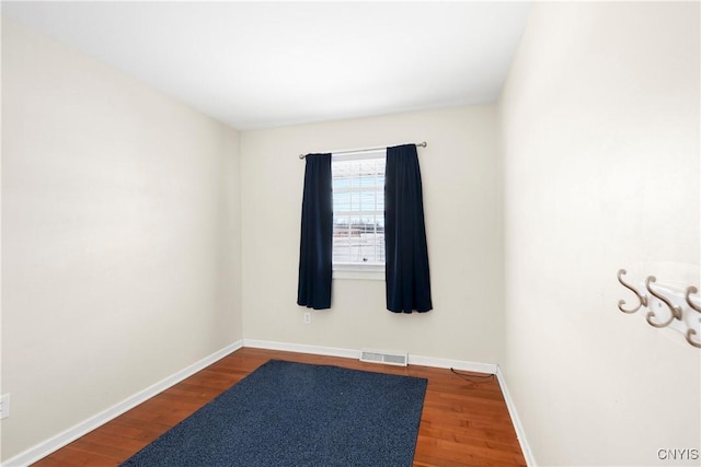 unfurnished room with hardwood / wood-style flooring