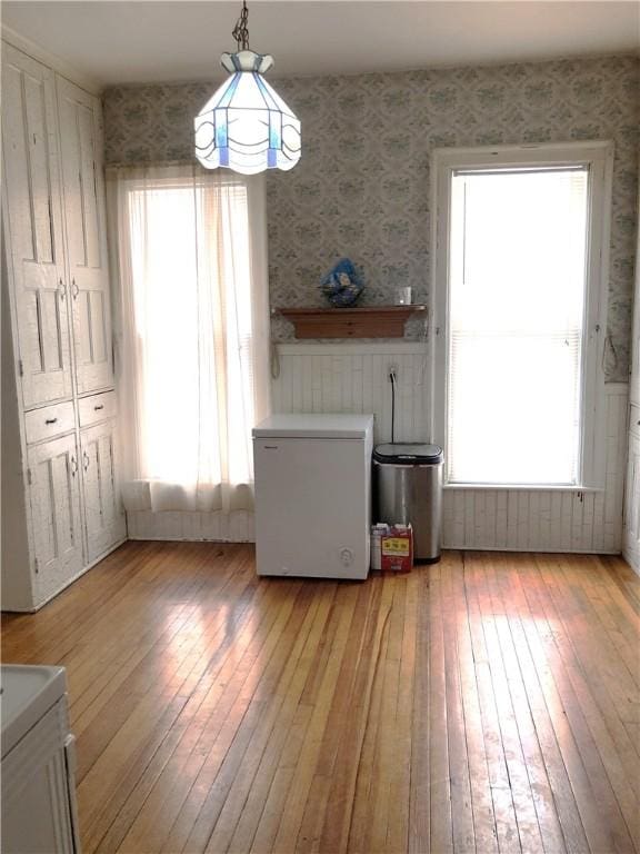 unfurnished dining area featuring light hardwood / wood-style flooring