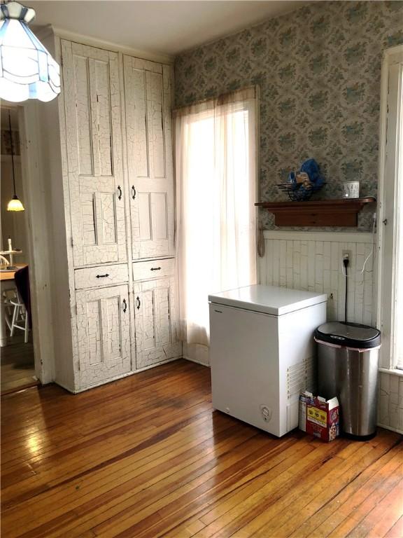 clothes washing area with light hardwood / wood-style floors