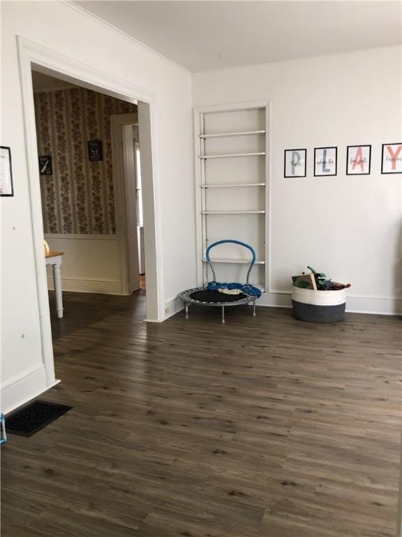 living area featuring built in features and dark hardwood / wood-style floors