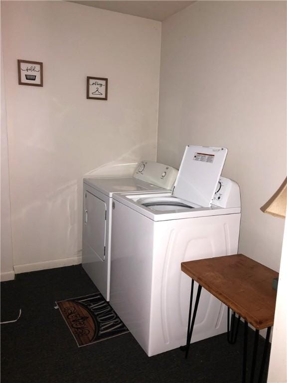 clothes washing area with washer and clothes dryer