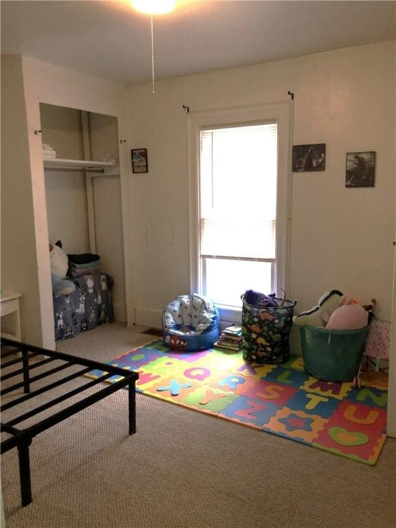 carpeted bedroom with a closet