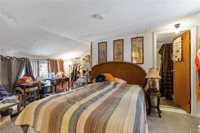 bedroom featuring a textured ceiling and light colored carpet