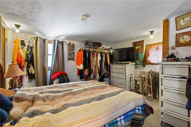 carpeted bedroom with a textured ceiling